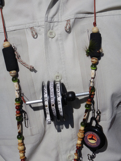 Fly fishing lanyard being worn with tippet spools and retractor.